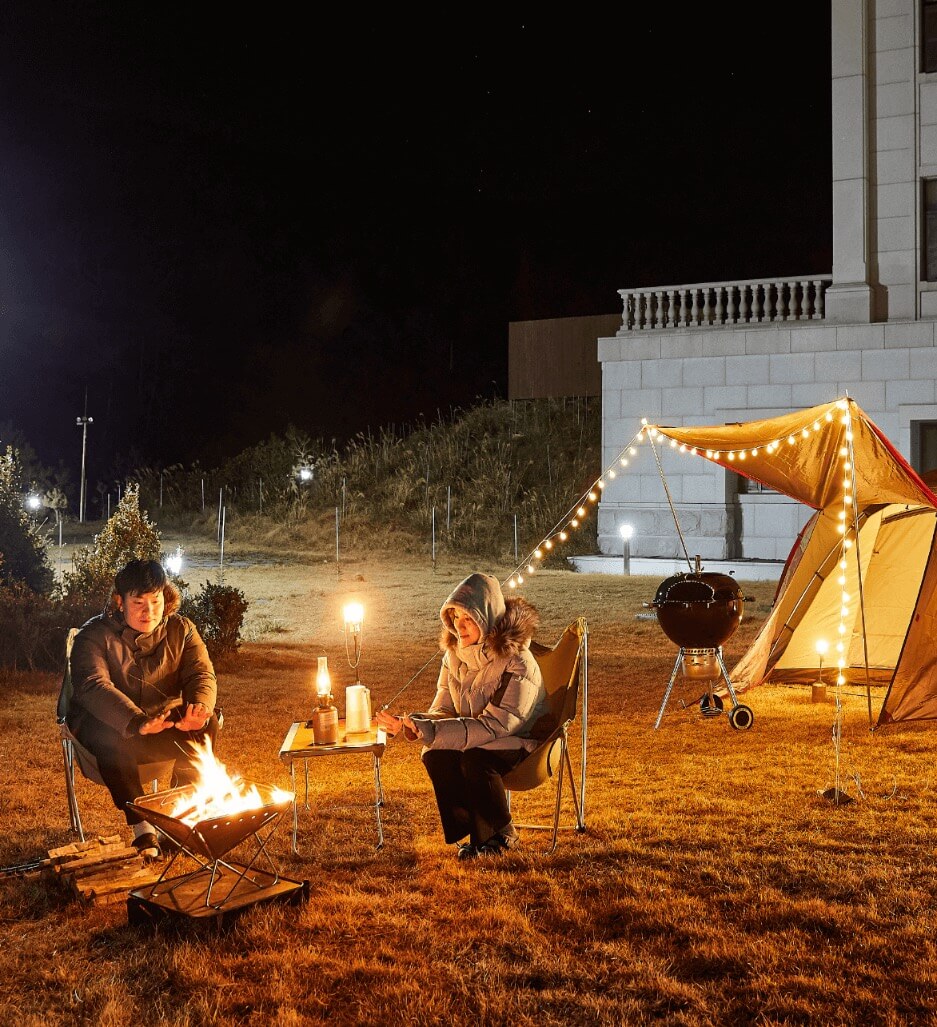 two people warming up in front of a fireplace